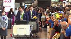 Japan swimming team return home