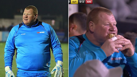 Sutton United reserve keeper Wayne Shaw EATS A PIE during FA Cup game v Arsenal