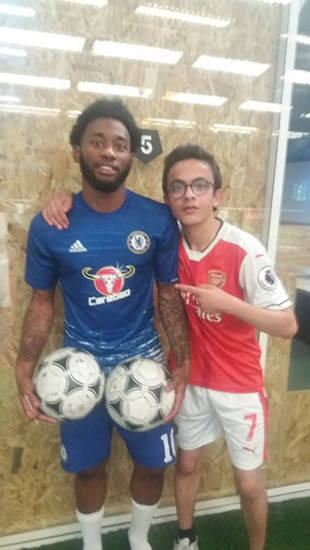 Tottenham’s NKoudou posing in a full Chelsea kit with an Arsenal fan