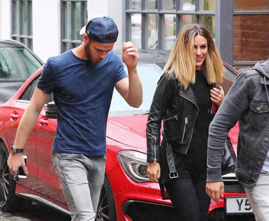 Manchester United star David De Gea heads out to lunch with stunning girlfriend Edurne Garcia as keeper shields himself from downpour