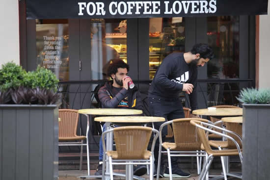 Manchester City star Sergio Aguero heads out for lunch while Liverpool's Mohamed Salah goes for coffee up the road in Cheshire