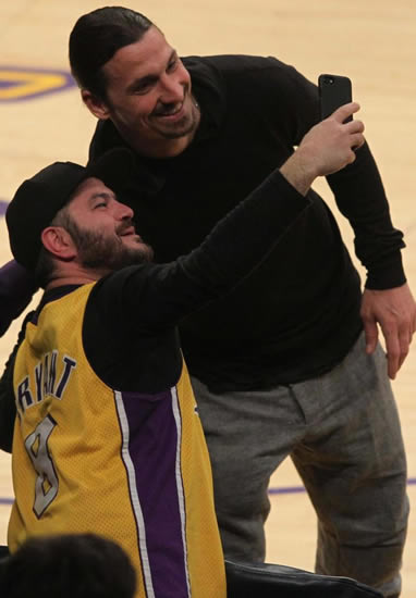 Zlatan Ibrahimovic sits courtside after meeting LA Lakers stars including the legendary Shaquille O'Neal