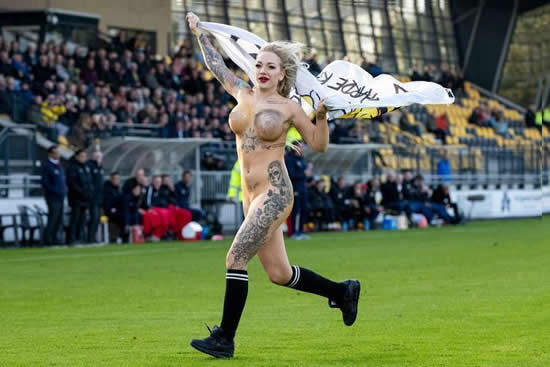 Dutch football fans hire busty tattooed STRIPPER to invade pitch wearing nothing more than body paint