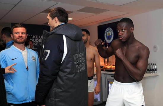 Benjamin Mendy pretends to punch Oleksandr Usyk as cruiserweight champ celebrates in City locker room after derby win over Manchester United