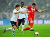 Robert Lewandowski of Poland is challenged by Leighton Baines of England as the game begins at a thundrous tempo