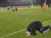 Belmadi slumps to the grass with his head in his hands as Algeria's dreams were crushed Credit: AFP